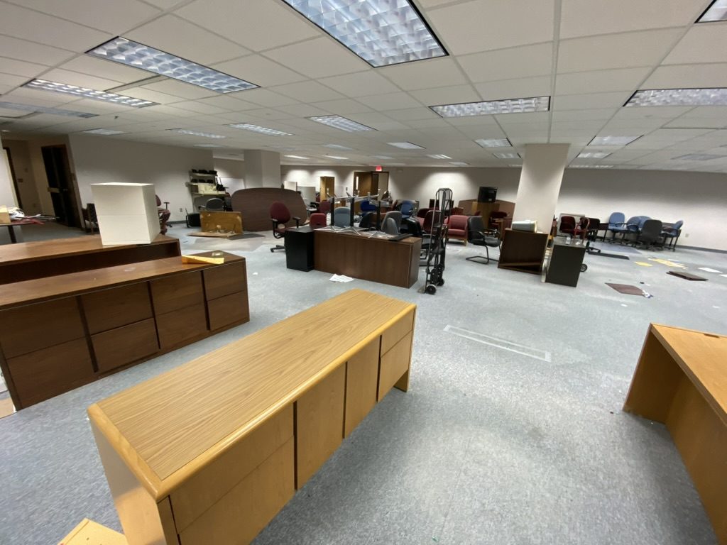 Commercial interior with desks, counters, chairs, and equipment